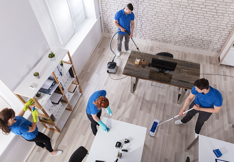 Cleaning Team Tidying Up Office