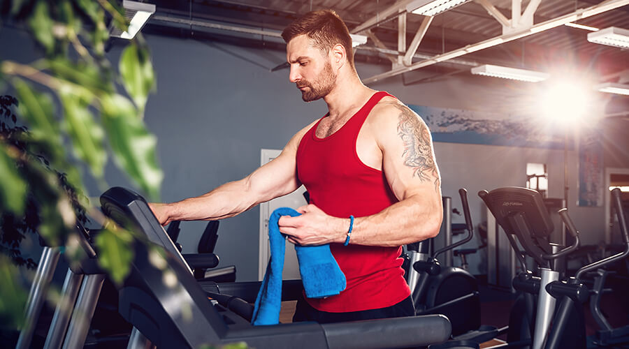 Man cleaning gym equipment